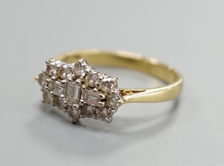 A modern 18ct gold and diamond cluster dress ring, size P, gross weight 4.2 grams, set with round and baguette cut stones.